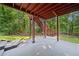 Exterior patio area featuring a painted red beam ceiling with access to yard and woods at 1575 Wynridge Pointe, Alpharetta, GA 30005