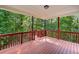 Spacious back porch featuring a painted wood floor, railing, and natural green view at 1575 Wynridge Pointe, Alpharetta, GA 30005