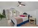 Bright bedroom with a blue bed frame, plush bedding, and fresh decor with a ceiling fan at 1634 Glenwood Se Ave, Atlanta, GA 30316