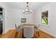 Cozy dining room with a modern chandelier, hardwood floors, and a window with natural light at 1634 Glenwood Se Ave, Atlanta, GA 30316