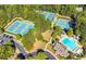 Aerial view of tennis courts and pool in a beautiful community surrounded by lush landscaping at 5355 Highland Pine Ln, Mableton, GA 30126