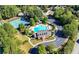 Scenic aerial view of community with tennis courts and a luxurious pool, creating a resort-like feel at 5355 Highland Pine Ln, Mableton, GA 30126