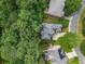Aerial view of the home showcasing its location in a wooded residential area at 5355 Highland Pine Ln, Mableton, GA 30126