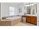 Bathroom featuring a large soaking tub, double vanities and tile floors at 5355 Highland Pine Ln, Mableton, GA 30126