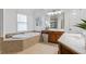 Bathroom featuring a large soaking tub, double vanities and tile floors at 5355 Highland Pine Ln, Mableton, GA 30126