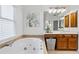 Bathroom featuring a large soaking tub, double vanities and tile floors at 5355 Highland Pine Ln, Mableton, GA 30126