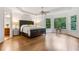 Large bedroom boasts a ceiling fan, hardwood floors, and natural light at 5355 Highland Pine Ln, Mableton, GA 30126