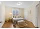 Cozy bedroom features a natural light, warm colors, hardwood floors, and crown molding at 5355 Highland Pine Ln, Mableton, GA 30126