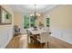 Traditional dining room with hardwood floors, classic wainscoting, a chandelier, and a view to the trees at 5355 Highland Pine Ln, Mableton, GA 30126