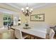A brightly lit dining area showcasing a table with seating, seamlessly connecting to a dedicated office space at 5355 Highland Pine Ln, Mableton, GA 30126