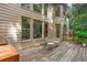 Exterior view of a two-story house with a wooden deck and an outdoor grill at 5355 Highland Pine Ln, Mableton, GA 30126
