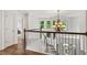 Bright hallway with hardwood floors, chandelier, and white staircase at 5355 Highland Pine Ln, Mableton, GA 30126