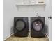 Well-equipped laundry room with modern black washer and dryer units at 5355 Highland Pine Ln, Mableton, GA 30126
