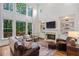 Open living room with large windows, built-ins and a cozy seating area at 5355 Highland Pine Ln, Mableton, GA 30126