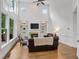 Bright living room with a fireplace, built-in shelving, and natural light at 5355 Highland Pine Ln, Mableton, GA 30126