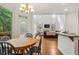 Open-concept living area with hardwood floors, a dining table and kitchen bar at 5355 Highland Pine Ln, Mableton, GA 30126