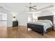 Spacious main bedroom with hardwood floors, tray ceiling and a ceiling fan at 5355 Highland Pine Ln, Mableton, GA 30126
