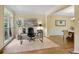 Bright office space with natural light, hardwood floors, adjacent to a dining area with table and chairs at 5355 Highland Pine Ln, Mableton, GA 30126
