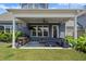 The covered patio has comfortable seating, a grill, and a view of the well-maintained lawn at 876 Samples Nw Ln, Atlanta, GA 30318