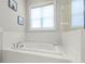 Stylish bathroom featuring a soaking tub with white subway tile surround at 876 Samples Nw Ln, Atlanta, GA 30318