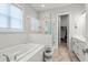Elegant bathroom featuring a glass enclosed shower, soaking tub, and double vanity at 876 Samples Nw Ln, Atlanta, GA 30318