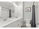 Well-lit bathroom boasts double sinks, modern fixtures, and neutral-toned shower and toilet at 876 Samples Nw Ln, Atlanta, GA 30318