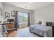 Bright bedroom with hardwood floors, a large window, and a desk area by the bed at 876 Samples Nw Ln, Atlanta, GA 30318