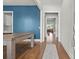 Elegant dining room featuring hardwood floors, a blue accent wall, and a billiard table at 876 Samples Nw Ln, Atlanta, GA 30318