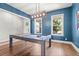 Elegant dining room featuring hardwood floors, a billiard table, and ample natural light at 876 Samples Nw Ln, Atlanta, GA 30318