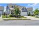 Charming blue two-story home featuring a welcoming front porch and well-manicured lawn at 876 Samples Nw Ln, Atlanta, GA 30318