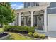Inviting front porch featuring hanging chairs, stylish lighting, and well-maintained landscaping at 876 Samples Nw Ln, Atlanta, GA 30318