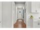 Bright hallway featuring hardwood floors, white trim, and a view into the kitchen at 876 Samples Nw Ln, Atlanta, GA 30318