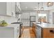 Bright kitchen features white cabinets, stainless steel appliances, and quartz countertops at 876 Samples Nw Ln, Atlanta, GA 30318