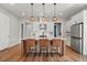 Modern kitchen island with seating, stainless steel appliances and custom cabinetry at 876 Samples Nw Ln, Atlanta, GA 30318