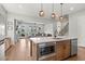 Kitchen island with seating and modern lighting opens to the spacious living area at 876 Samples Nw Ln, Atlanta, GA 30318