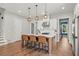Island with barstool seating, stylish pendant lights, and white cabinets in open concept kitchen at 876 Samples Nw Ln, Atlanta, GA 30318