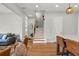 Bright living room with hardwood floors, staircase, and modern light fixtures at 876 Samples Nw Ln, Atlanta, GA 30318
