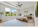 Bright main bedroom with large window, tray ceiling, ceiling fan, and en suite bathroom at 876 Samples Nw Ln, Atlanta, GA 30318
