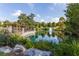 Scenic pond view surrounded by lush greenery, trees, and wooden pergola at 876 Samples Nw Ln, Atlanta, GA 30318