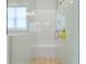 Modern shower features glass door, tile surround, and built-in bench at 876 Samples Nw Ln, Atlanta, GA 30318