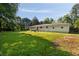 Well-maintained backyard with a mix of green grass and shady trees, creating a serene and inviting outdoor space at 159 Lloyd Dr, Marietta, GA 30066