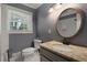 Updated bathroom with granite vanity, oval mirror and marble-tiled walk-in shower at 159 Lloyd Dr, Marietta, GA 30066