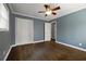 Blue bedroom with ceiling fan, crown molding, hardwood floors and walk-in closet at 159 Lloyd Dr, Marietta, GA 30066