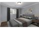 Neutral bedroom with natural light, hardwood flooring and an upholstered bench at 159 Lloyd Dr, Marietta, GA 30066