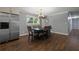 Dining room with wood-look tile flooring adjacent to a stainless steel refrigerator and kitchen at 159 Lloyd Dr, Marietta, GA 30066