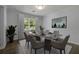 Dining room with a modern glass-top table set for six, with a light fixture and natural light at 159 Lloyd Dr, Marietta, GA 30066