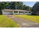 Classic single-story home featuring a brick exterior, attached garage, and traditional landscaping at 159 Lloyd Dr, Marietta, GA 30066
