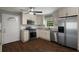 Updated kitchen with stainless steel appliances, white cabinets, and wood-look tile flooring at 159 Lloyd Dr, Marietta, GA 30066