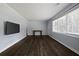 Neutral color scheme and hardwood floors enhance this living room with a large picture window at 159 Lloyd Dr, Marietta, GA 30066