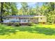 Large backyard with a deck and patio offering serene outdoor living at 1445 Woodhill Dr, Marietta, GA 30066